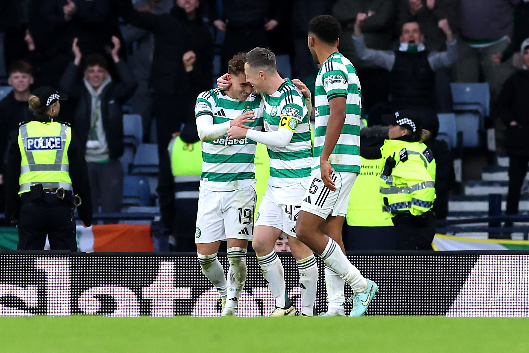 Celtic players celebrate a goal against Rangers