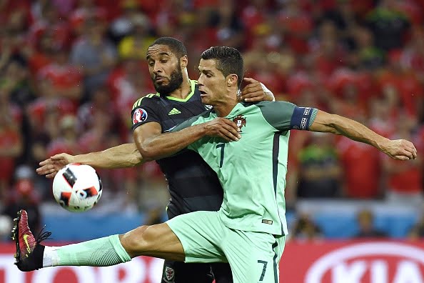 Wales' defender Ashley Williams (L) vies for the ball against Portugal's forward Cristiano Ronaldo during the Euro 2016 semi-final football match between Portugal and Wales at the Parc Olympique Lyonnais stadium in Décines-Charpieu, near Lyon, on July 6, 2016.
 / AFP / PHILIPPE DESMAZES        (Photo credit should read PHILIPPE DESMAZES/AFP/Getty Images)