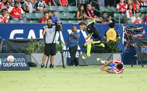 Arsenal defender Mathieu Debuchy (Top) leaps over Chivas Guadalajara defender Hedgardo Marin during their friendly soccer match at StubHub Center in Carson, California on July 31, 2016. Arsenal won 3-0. / AFP / RINGO CHIU        (Photo credit should read RINGO CHIU/AFP/Getty Images)