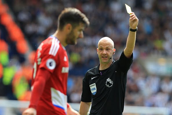 Middlesbrough's Spanish defender Antonio Barragan receives a yellow card from referee Anthony Taylor, booked for dissent during the English Premier League football match between West Bromwich Albion and Middlesbrough at The Hawthorns stadium in West Bromwich, central England, on August 28, 2016.
 / AFP / Lindsey PARNABY / RESTRICTED TO EDITORIAL USE. No use with unauthorized audio, video, data, fixture lists, club/league logos or 'live' services. Online in-match use limited to 75 images, no video emulation. No use in betting, games or single club/league/player publications.  /         (Photo credit should read LINDSEY PARNABY/AFP/Getty Images)