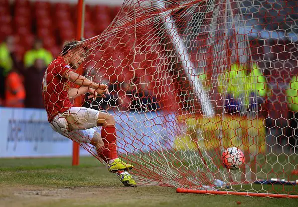 NOTTINGHAM, ENGLAND - JANUARY 09:  Jamie Ward of Nottingham Forest gets tangled in the goal net as his team-mate Oliver Burke scores the opening goal during The Emirates FA Cup Third Round match between Nottingham Forest and Queens Park Rangers at City Ground on January 9, 2016 in Nottingham, England.  (Photo by Tony Marshall/Getty Images)