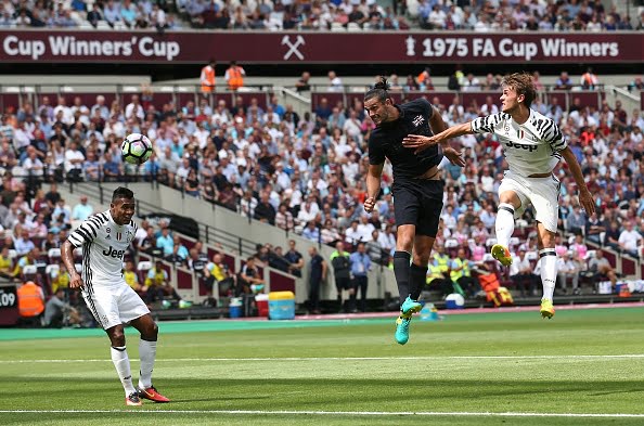 West Ham United's English striker Andy Carroll (C) heads the ball toward goal before scoring their first goal during the pre-season friendly football match between West Ham United and Juventus at the London Stadium in east London on August 7, 2016. / AFP / JUSTIN TALLIS        (Photo credit should read JUSTIN TALLIS/AFP/Getty Images)