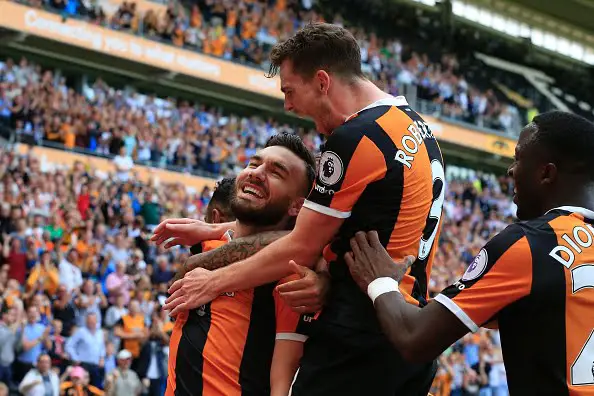 Hull City's Scottish midfielder Robert Snodgrass (L) celebrates with Hull City's Norwegian striker Adama Diomande (R) and Hull City's Scottish defender Andrew Robertson (C) after scoring their second goal during the English Premier League football match between Hull City and Leicester City at the KCOM Stadium in Kingston upon Hull, north east England on August 13, 2016. / AFP / Lindsey PARNABY / RESTRICTED TO EDITORIAL USE. No use with unauthorized audio, video, data, fixture lists, club/league logos or 'live' services. Online in-match use limited to 75 images, no video emulation. No use in betting, games or single club/league/player publications.  /         (Photo credit should read LINDSEY PARNABY/AFP/Getty Images)