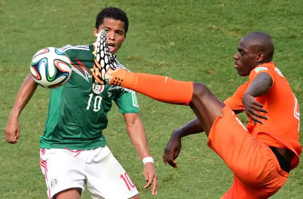 Mexico's forward Giovani Dos Santos (L) and Netherlands' defender Bruno Martins Indi vie for the ball during a Round of 16 football match between Netherlands and Mexico at Castelao Stadium in Fortaleza during the 2014 FIFA World Cup on June 29, 2014. AFP PHOTO / JAVIER SORIANO        (Photo credit should read JAVIER SORIANO/AFP/Getty Images)