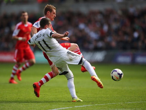 SWANSEA, WALES - MAY 03:  Pablo Hernandez of Swansea City battles with Steven Davis of Southampton during the Barclays Premier League match between Swansea City and Southampton at Liberty Stadium on May 3, 2014 in Swansea, Wales.  (Photo by Clive Rose/Getty Images)