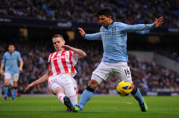 MANCHESTER, ENGLAND - JANUARY 01:  Sergio Aguero of Manchester City is challenged by Ryan Shawcross of Stoke City during the Barclays Premier League match between Manchester City and Stoke City at the Etihad Stadium on January 1, 2013 in Manchester, England. (Photo by Michael Regan/Getty Images)