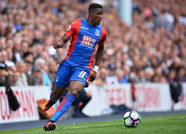 Crystal Palace's Ivorian-born English striker Wilfried Zaha runs with the ball during the English Premier League football match between Tottenham Hotspur and Crystal Palace at White Hart Lane in London, on August 20, 2016. / AFP / Glyn KIRK / RESTRICTED TO EDITORIAL USE. No use with unauthorized audio, video, data, fixture lists, club/league logos or 'live' services. Online in-match use limited to 75 images, no video emulation. No use in betting, games or single club/league/player publications.  /         (Photo credit should read GLYN KIRK/AFP/Getty Images)