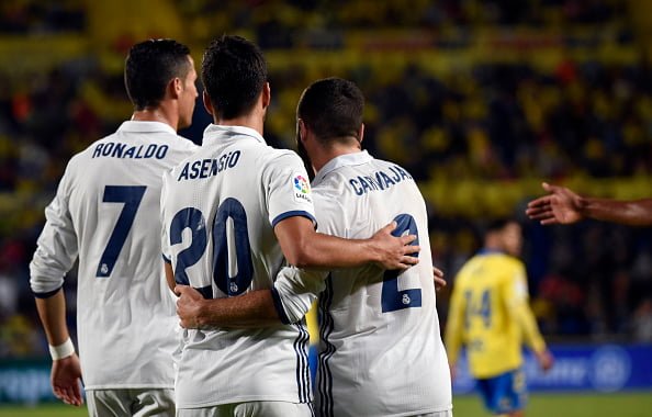 Real Madrid's Portuguese forward Cristiano Ronaldo (L), Real Madrid's forward Marco Asensio Willemsen (C) and Real Madrid's defender Daniel Carvajal Ramos celebrate a goal during the Spanish league football match UD Las Palmas vs Real Madrid CF at the Gran Canaria stadium in Las Palmas de Gran Canaria on September 24, 2016. / AFP / DESIREE MARTIN        (Photo credit should read DESIREE MARTIN/AFP/Getty Images)