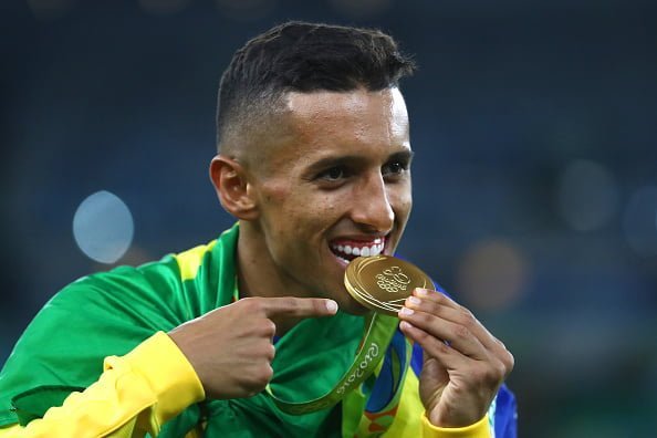 RIO DE JANEIRO, BRAZIL - AUGUST 20:  Marquinhos of Brazil celebrates with his gold medal following the Men's Football Final between Brazil and Germany at the Maracana Stadium on Day 15 of the Rio 2016 Olympic Games on August 20, 2016 in Rio de Janeiro, Brazil.  (Photo by Clive Mason/Getty Images)