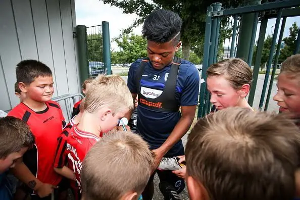 Genk's Jamaican winger Leon Bailey signs autographs as he arrives for a training session of Belgian first league soccer team , on July 13, 2016, in Genk, one day before their Europa League competition first leg of the second qualification round match against Montenegro's team Buducnost Podgorica. / AFP / BELGA / VIRGINIE LEFOUR / Belgium OUT        (Photo credit should read VIRGINIE LEFOUR/AFP/Getty Images)