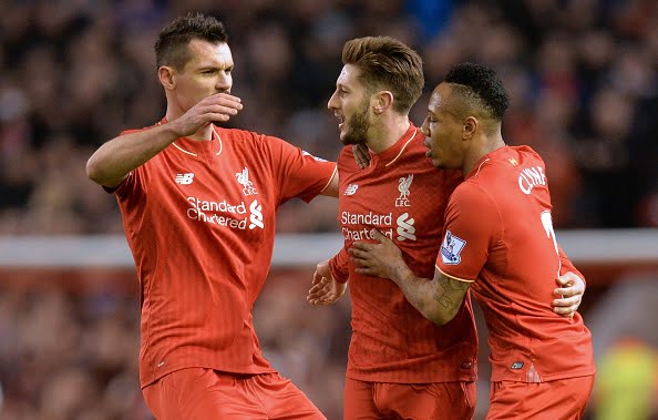 Liverpool's English midfielder Adam Lallana (C) celebrates with Liverpool's Croatian defender Dejan Lovren (L) and Liverpool's English defender Nathaniel Clyne after scoring the opening goal of the English Premier League football match between Liverpool and Manchester City at Anfield in Liverpool, northwest England on March 2, 2016. (PAUL ELLIS/AFP/Getty Images)
