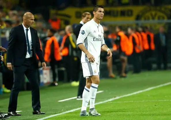 Real Madrid's French coach Zinedine Zidane (L) and Real Madrid's Portuguese forward Cristiano Ronaldo react during the UEFA Champions League first leg football match between Borussia Dortmund and Real Madrid at BVB stadium in Dortmund, on September 27, 2016. / AFP / Odd ANDERSEN        (Photo credit should read ODD ANDERSEN/AFP/Getty Images)