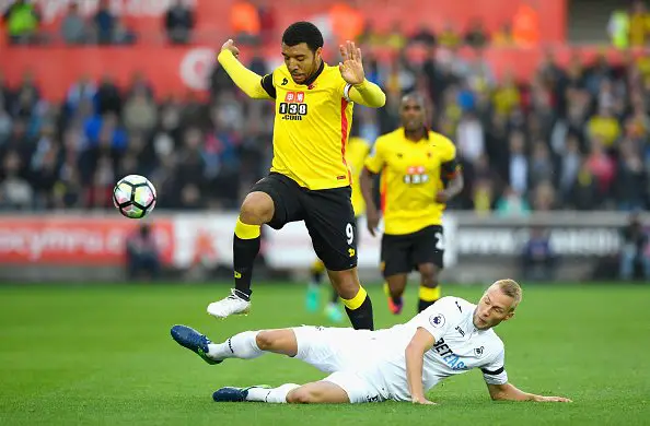 SWANSEA, WALES - OCTOBER 22: Troy Deeney of Watford is tackled by Mike van der Hoorn of Swansea City during the Premier League match between Swansea City and Watford at the Liberty Stadium on October 22, 2016 in Swansea, Wales.  (Photo by Stu Forster/Getty Images)