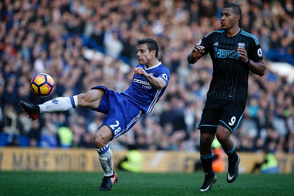 Chelsea's Spanish defender Cesar Azpilicueta (L) clears the ball under pressure from West Bromwich Albion's Venezuelan striker Salomon Rondon during the English Premier League football match between Chelsea and West Bromwich Albion at Stamford Bridge in London on December 11, 2016. / AFP / Adrian DENNIS / RESTRICTED TO EDITORIAL USE. No use with unauthorized audio, video, data, fixture lists, club/league logos or 'live' services. Online in-match use limited to 75 images, no video emulation. No use in betting, games or single club/league/player publications.  /         (Photo credit should read ADRIAN DENNIS/AFP/Getty Images)