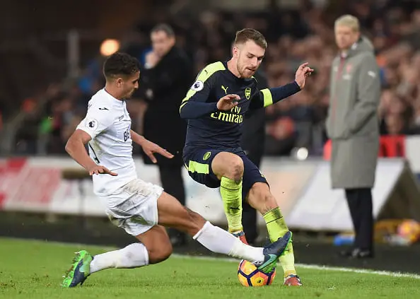 SWANSEA, WALES - JANUARY 14: Kyle Naughton of Swansea City (L) tackles Aaron Ramsey of Arsenal (R) during the Premier League match between Swansea City and Arsenal at Liberty Stadium on January 14, 2017 in Swansea, Wales.  (Photo by Tony Marshall/Getty Images)