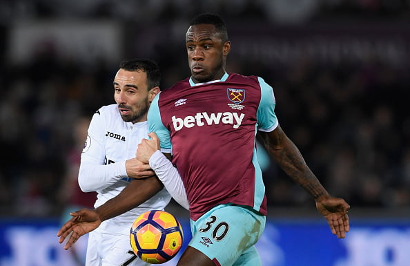 SWANSEA, WALES - DECEMBER 26:  Leon Britton of Swansea City (l) challenges Michail Antonio of West Ham United during the Premier League match between Swansea City and West Ham United at Liberty Stadium on December 26, 2016 in Swansea, Wales.  (Photo by Stu Forster/Getty Images)