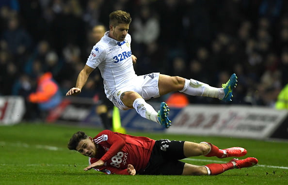 Gaetano Berardi of Leeds United rides a tackle from Matty Cash of Nottingham Forest during the Sky Bet Championship match between Leeds United and Nottingham Forest at Elland Road on January 25, 2017 in Leeds, England.  (Photo by Gareth Copley/Getty Images)