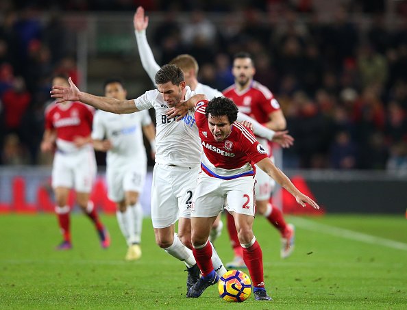 MIDDLESBROUGH, ENGLAND - DECEMBER 17:  Angel Rangel of Swansea City (L) and Fabio Da Silva of Middlesbrough (R) battle for possession during the Premier League match between Middlesbrough and Swansea City at Riverside Stadium on December 17, 2016 in Middlesbrough, England.  (Photo by Alex Livesey/Getty Images)