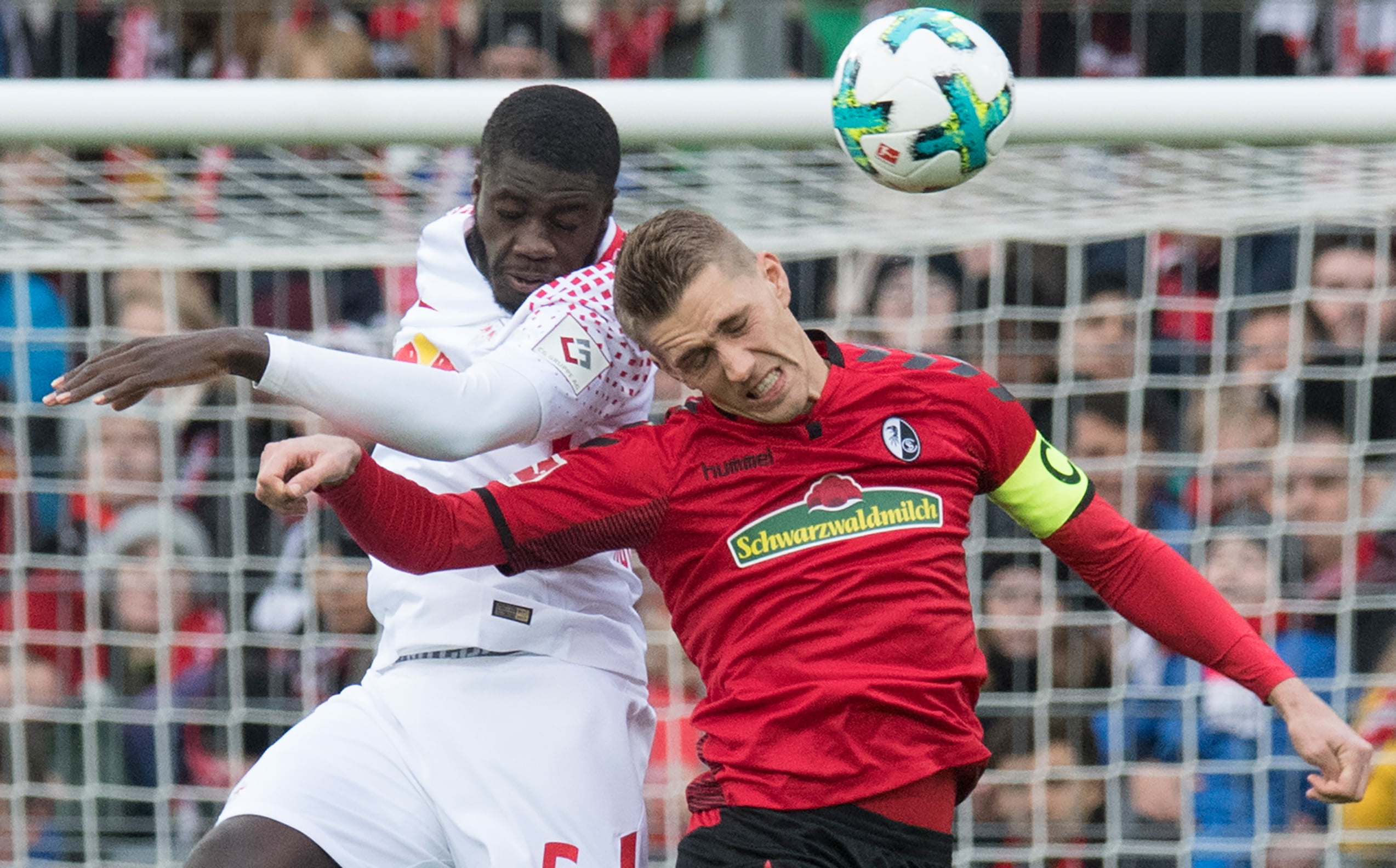 Freiburg's German forward Nils Petersen (R) and Leipzig's French defender Dayot Upamecano vie for the ball during the German first division Bundesliga football match SC Freiburg vs RB Leipzig in Freiburg, southwestern Germany, on January 20, 2018. / AFP PHOTO / THOMAS KIENZLE / RESTRICTIONS: DURING MATCH TIME: DFL RULES TO LIMIT THE ONLINE USAGE TO 15 PICTURES PER MATCH AND FORBID IMAGE SEQUENCES TO SIMULATE VIDEO. == RESTRICTED TO EDITORIAL USE == FOR FURTHER QUERIES PLEASE CONTACT DFL DIRECTLY AT + 49 69 650050
        (Photo credit should read THOMAS KIENZLE/AFP/Getty Images)