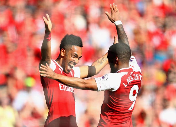 Pierre-Emerick Aubameyang of Arsenal celebrates after scoring his sides first goal with Alexandre Lacazette of Arsenal during the Premier League match between Arsenal and Burnley at Emirates Stadium on May 6, 2018 in London, England.  (Photo by Clive Mason/Getty Images)