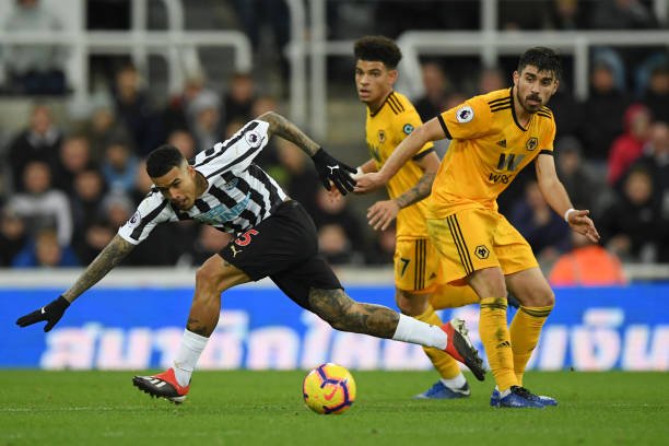 Kenedy of Newcastle United evades Ruben Neves of Wolverhampton Wanderers during the Premier League match between Newcastle United and Wolverhampton Wanderers at St. James Park on December 9, 2018 in Newcastle upon Tyne, United Kingdom. (Photo by Stu Forster/Getty Images)