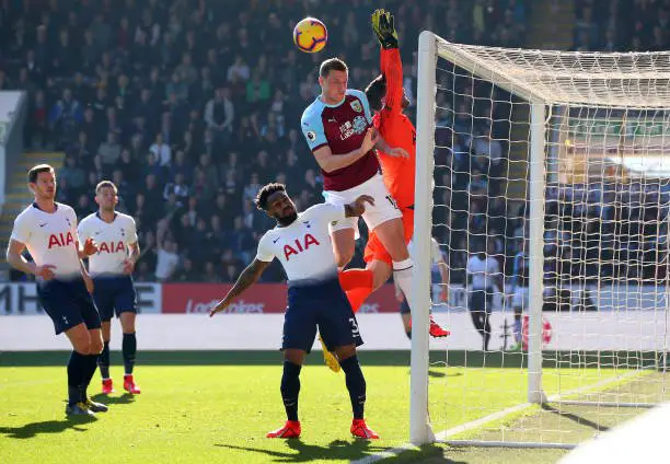 BURNLEY, ENGLAND - FEBRUARY 23: Chris Wood of Burnley challenges for the ball with Danny Rose and Hugo Lloris of Tottenham Hotspur during the Premier League match between Burnley FC and Tottenham Hotspur at Turf Moor on February 23, 2019 in Burnley, United Kingdom.  (Photo by Alex Livesey/Getty Images)