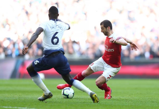 LONDON, ENGLAND - MARCH 02: Henrikh Mkhitaryan of Arsenal runs with the ball towards Davinson Sanchez of Tottenham Hotspur during the Premier League match between Tottenham Hotspur and Arsenal FC at Wembley Stadium on March 02, 2019 in London, United Kingdom. (Photo by Clive Rose/Getty Images)