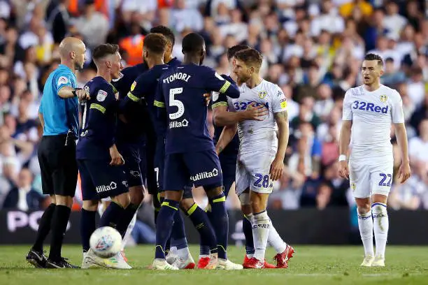 LEEDS, ENGLAND - MAY 15: Gaetano Berardi of Leeds United has words with referee Anthony Taylor during the Sky Bet Championship Play-off semi final second leg match between Leeds United and Derby County at Elland Road on May 15, 2019 in Leeds, England. (Photo by Alex Livesey/Getty Images)