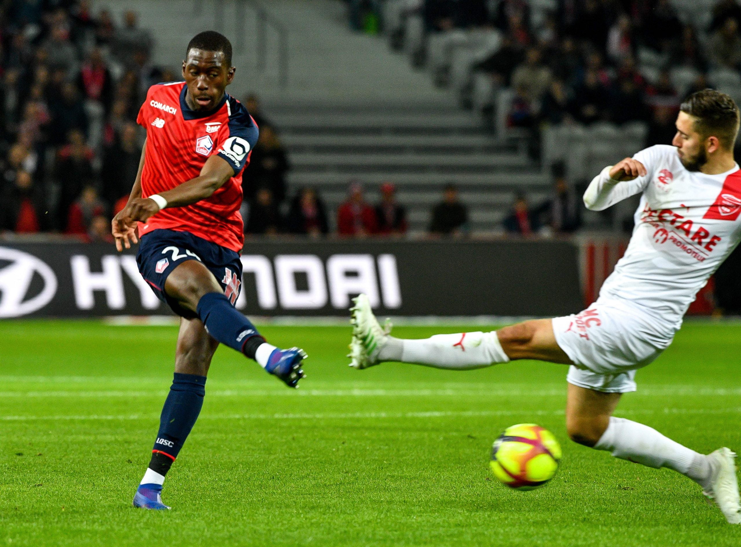 Lille's French midfielder Boubakary Soumare (L) vies with Nîmes' French defender Gaetan Paquiez during the French L1 football match between Lille LOSC and Nimes Olympique at the Pierre-Mauroy Stadium in Villenueve d'Ascq, northern France on April 28, 2019. (Photo by PHILIPPE HUGUEN / AFP)        (Photo credit should read PHILIPPE HUGUEN/AFP/Getty Images)