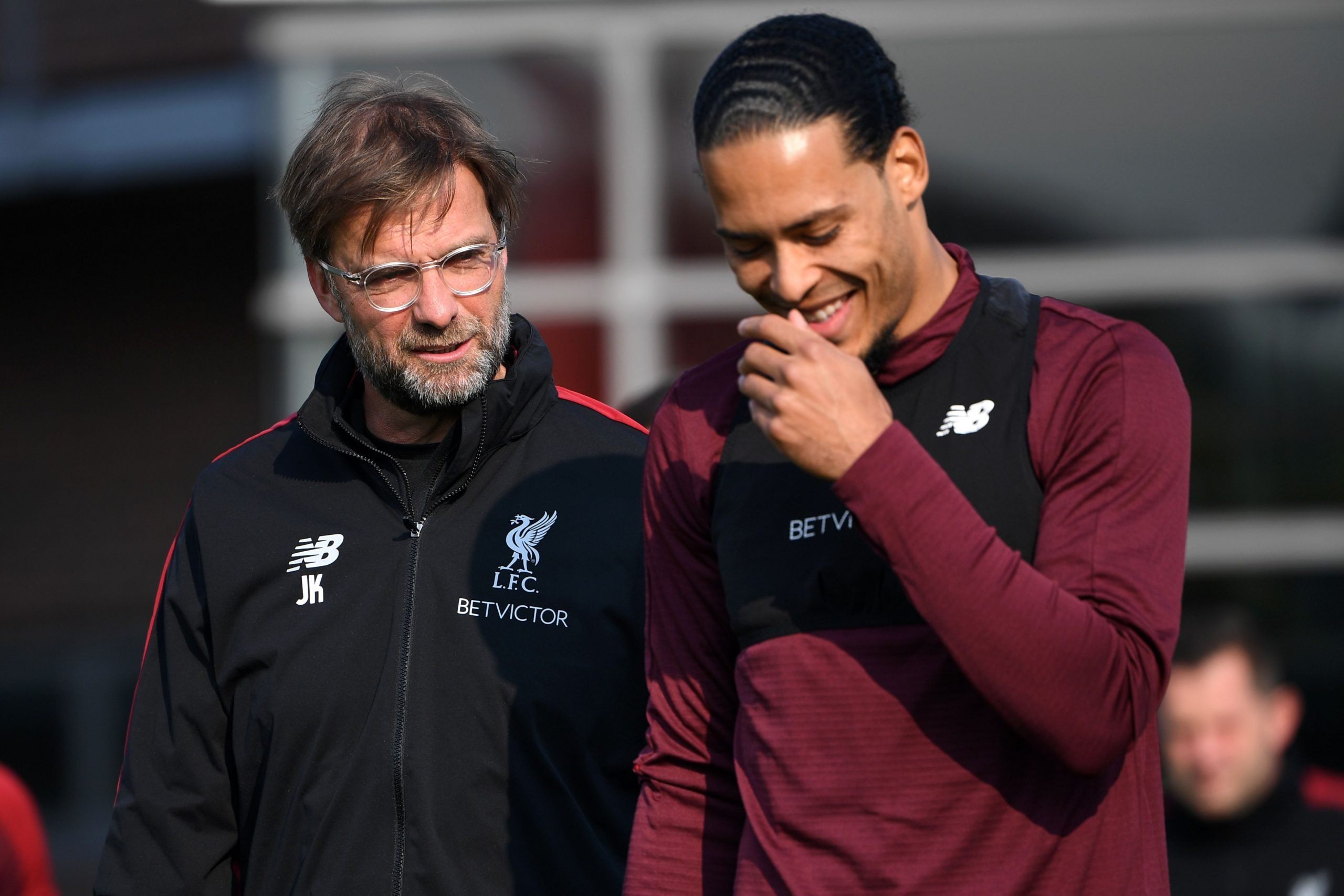 Liverpool's German manager Jurgen Klopp (L) chats with Liverpool's Dutch defender Virgil van Dijk (R) during a Liverpool team training session at Melwood in Liverpool, north west England on April 8, 2019, on the eve of their UEFA Champions League quarter final first leg football match against Porto. (Photo by Paul ELLIS / AFP)