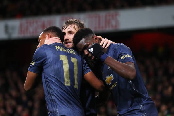 Anthony Martial of Manchester United (11) celebrates after scoring his team's third goal with Luke Shaw (C) and Paul Pogba (R) during the FA Cup Fourth Round match between Arsenal and Manchester United at Emirates Stadium on January 25, 2019 in London, United Kingdom. (Photo by Catherine Ivill/Getty Images)