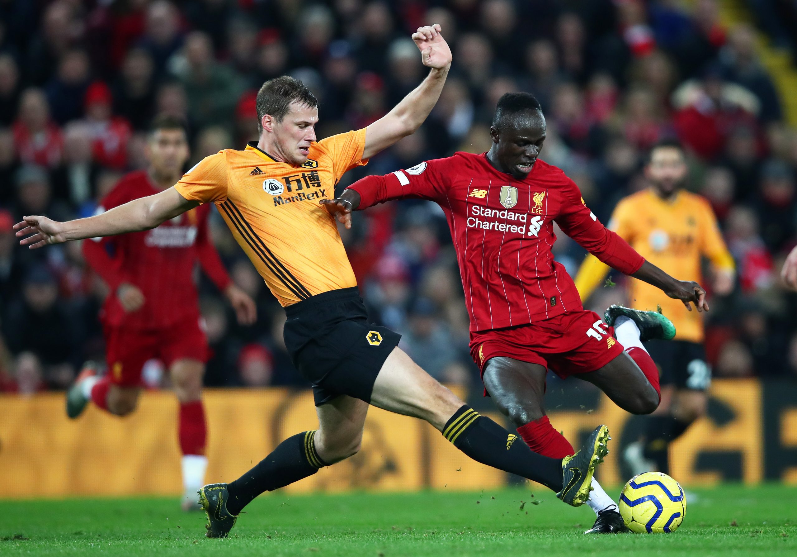 Sadio Mane of Liverpool closed down by Ryan Bennett of Wolverhampton Wanderers during the Premier League match between Liverpool FC and Wolverhampton Wanderers at Anfield on December 29, 2019 in Liverpool, United Kingdom. (Photo by Clive Brunskill/Getty Images)