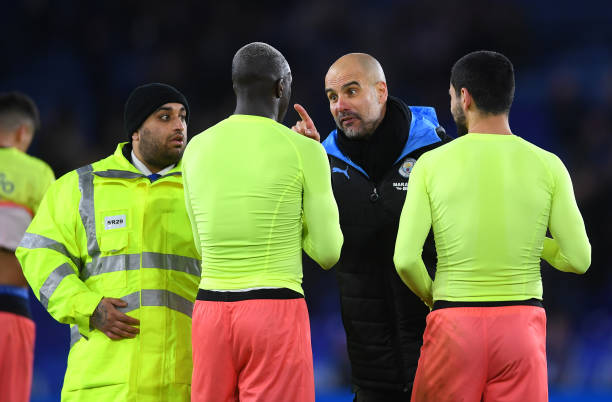 LEICESTER, ENGLAND - FEBRUARY 22: Pep Guardiola, Manager of Manchester City speaks to Benjamin Mendy of Manchester City during the Premier League match between Leicester City and Manchester City at The King Power Stadium on February 22, 2020 in Leicester, United Kingdom. (Photo by Laurence Griffiths/Getty Images)