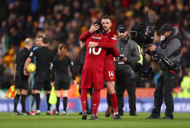 Sadio Mane and Jordan Henderson of Liverpool celebrate following their sides victory in the Premier League match between Norwich City and Liverpool FC at Carrow Road on February 15, 2020 in Norwich, United Kingdom. (Photo by Catherine Ivill/Getty Images)