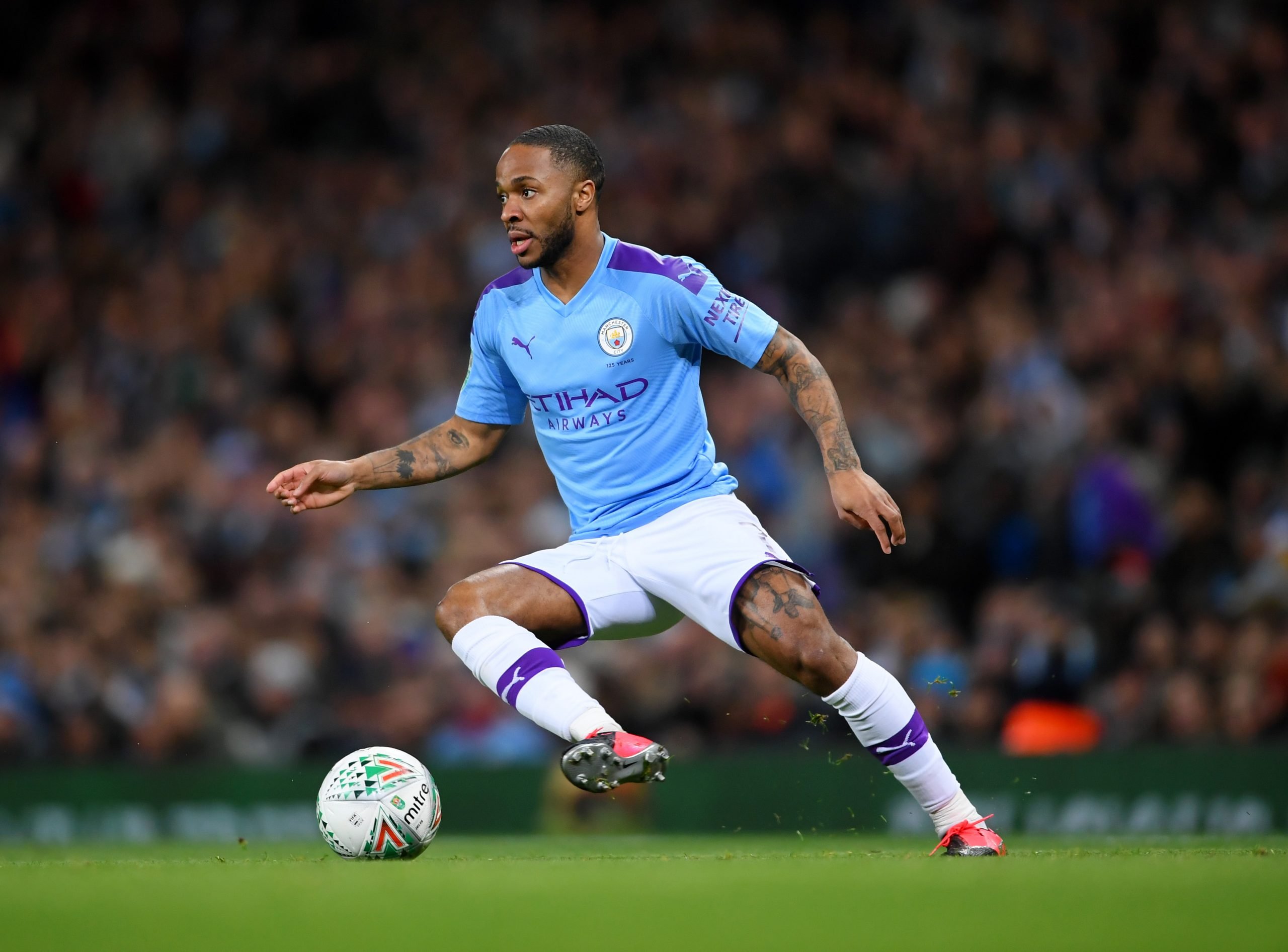 MANCHESTER, ENGLAND - JANUARY 29: Raheem Sterling of Manchester City runs with the ball during the Carabao Cup Semi Final match between Manchester City and Manchester United at Etihad Stadium on January 29, 2020 in Manchester, England. (Photo by Laurence Griffiths/Getty Images)