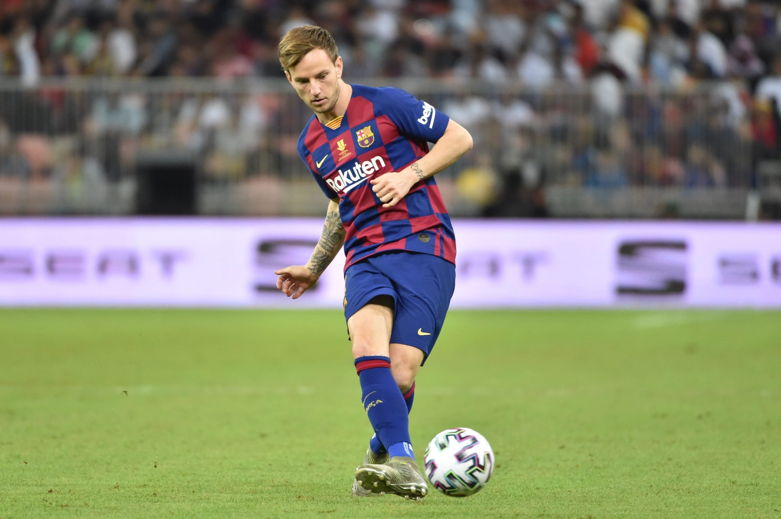 Barcelona's Croatian midfielder Ivan Rakitic passes the ball during the Spanish Super Cup semi final between Barcelona and Atletico Madrid on January 9, 2020, at the King Abdullah Sport City in the Saudi Arabian port city of Jeddah. - The winner will face Real Madrid in the final on January 12. (Photo by FAYEZ NURELDINE / AFP) (Photo by FAYEZ NURELDINE/AFP via Getty Images)