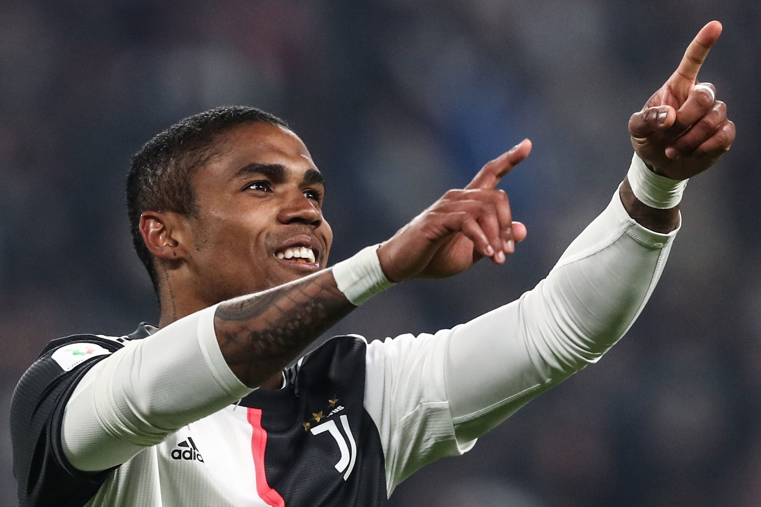 Juventus' Brazilian forward Douglas Costa celebrates after scoring a penalty and his team's fourth goal during the Italian Cup (Coppa Italia) round of 16 football match Juventus vs Udinese on January 15, 2020 at the Juventus stadium in Turin. (Photo by Isabella BONOTTO / AFP) (Photo by ISABELLA BONOTTO/AFP via Getty Images)
