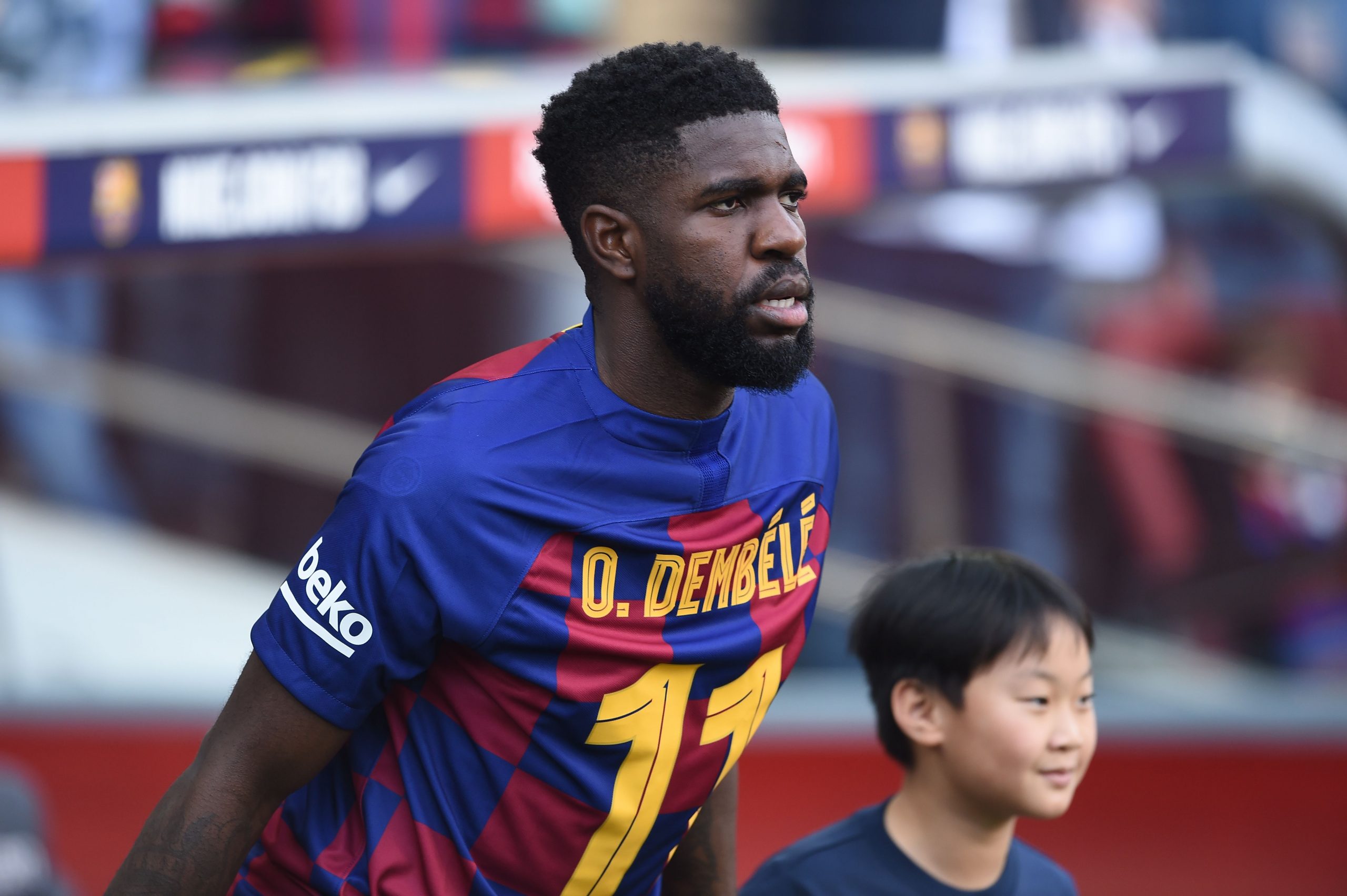 Barcelona's French defender Samuel Umtiti wears a jersey in support of teammate Barcelona's French forward Ousmane Dembele before the Spanish league football match between FC Barcelona and Getafe CF at the Camp Nou stadium in Barcelona on February 15, 2020.  (Photo by JOSEP LAGO/AFP via Getty Images)