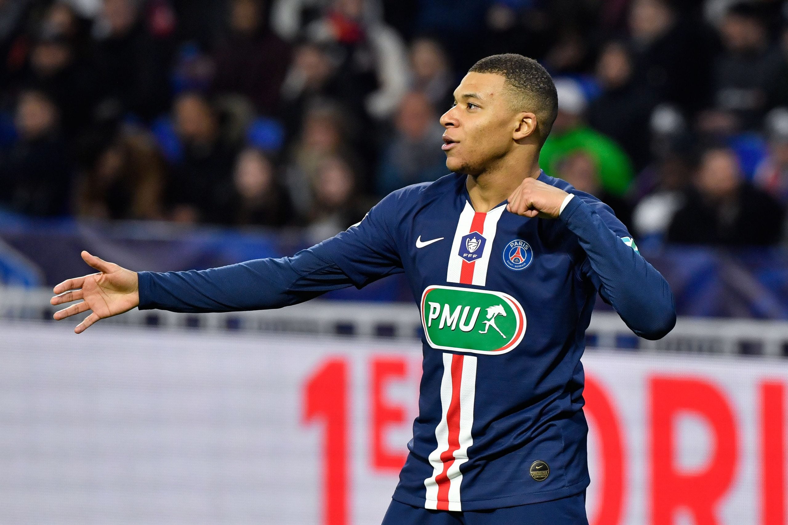 Paris Saint-Germain's French forward Kylian Mbappe celebrates after scoring a goal during the French Cup semi-final football match between Olympique Lyonnais (OL) and Paris Saint-Germain (PSG) at the Groupama Stadium in Decines-Charpieu, centraleastern France, on March 4, 2020. (Photo by Philippe DESMAZES / AFP) (Photo by PHILIPPE DESMAZES/AFP via Getty Images)