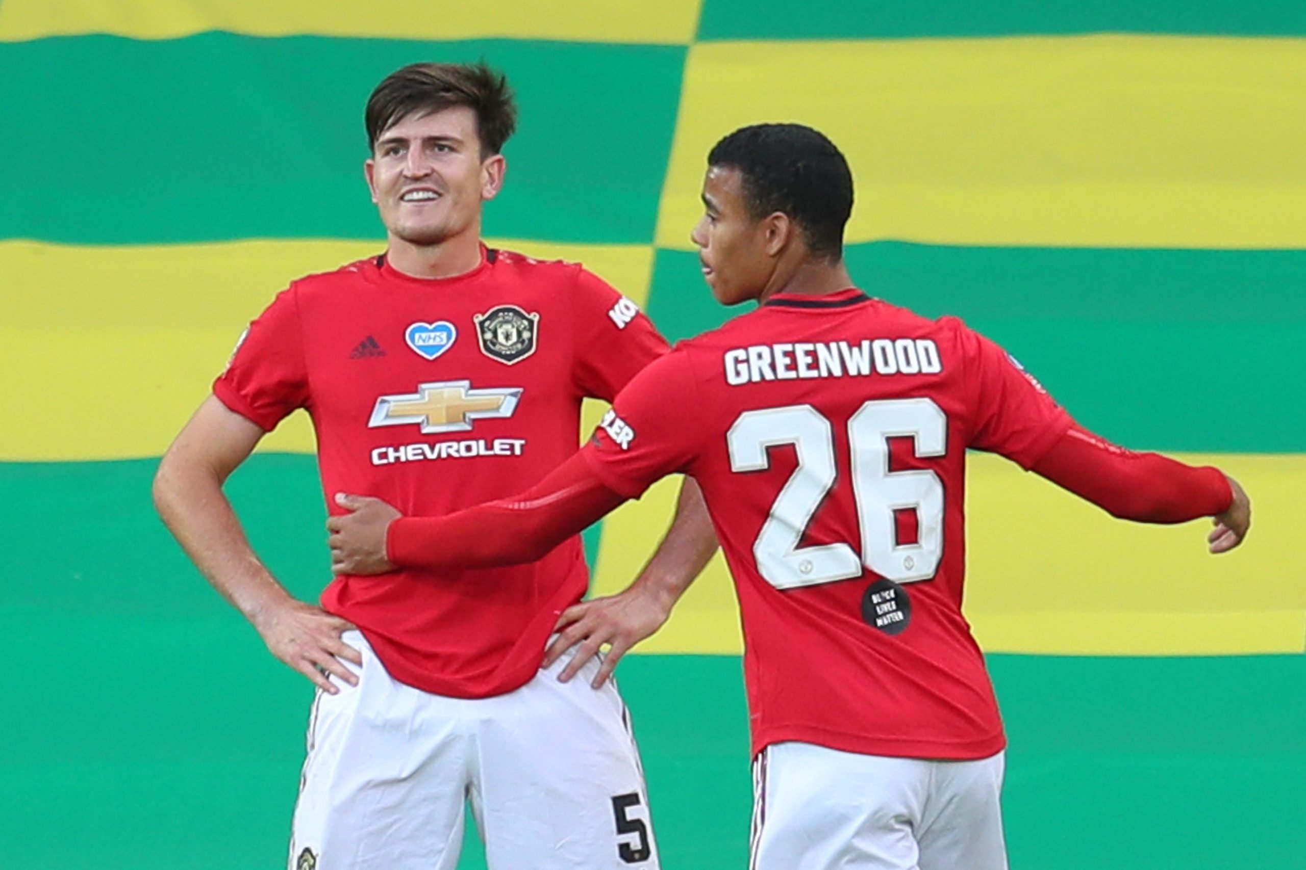 Manchester United's English defender Harry Maguire (L) celebrates scoring their second goal during the English FA Cup quarter-final football match between Norwich City and Manchester United at Carrow Road in Norwich, eastern England on June 27, 2020. (Photo by Catherine Ivill / POOL / AFP)