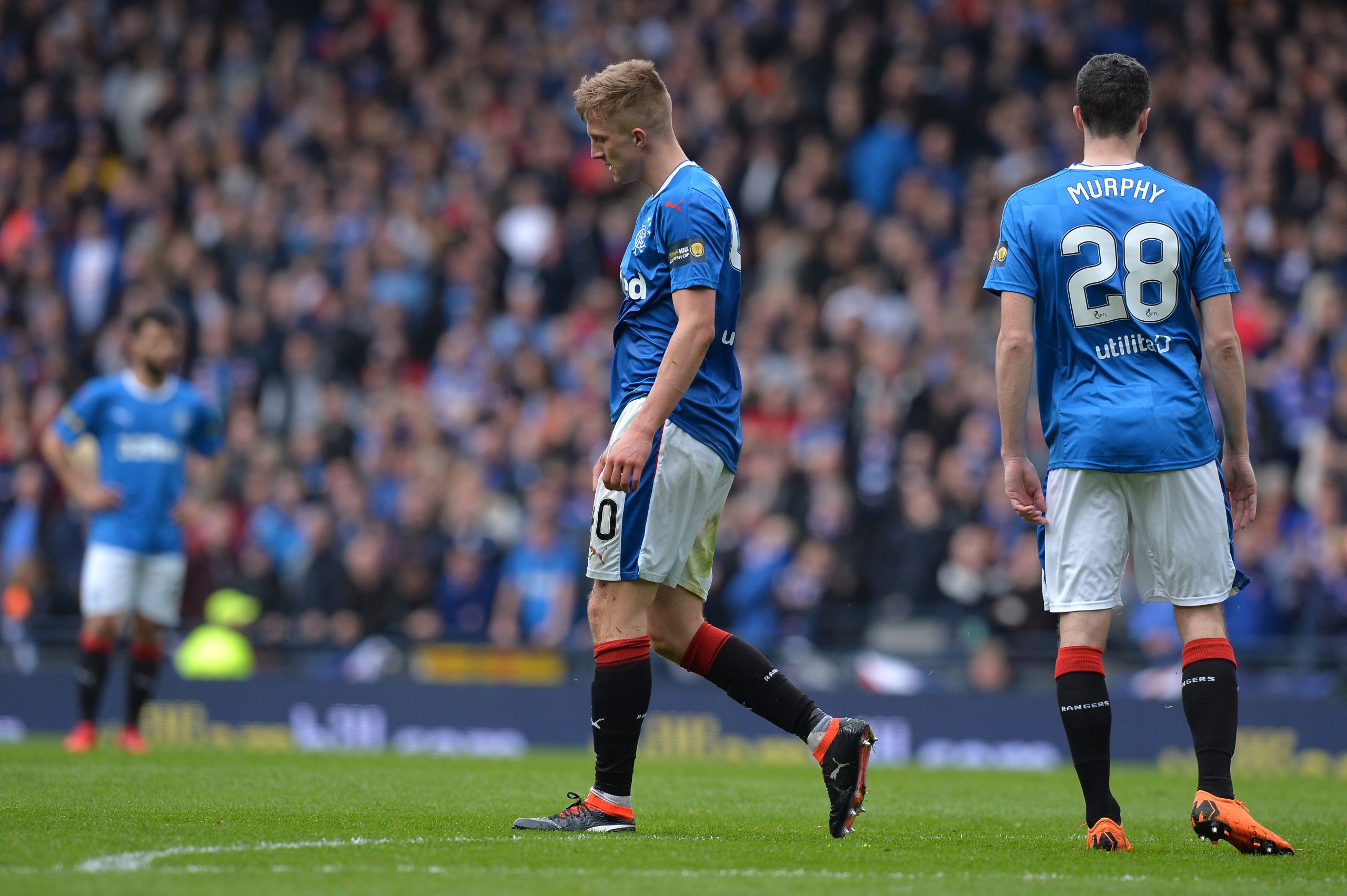 GLASGOW, SCOTLAND - APRIL 15:  Ross McCrorie of Rangers walks off after being sent off during the Scottish Cup Semi Final match between Rangers and Celtic at Hampden Park on April 15, 2018 in Glasgow, Scotland.  (Photo by Mark Runnacles/Getty Images)