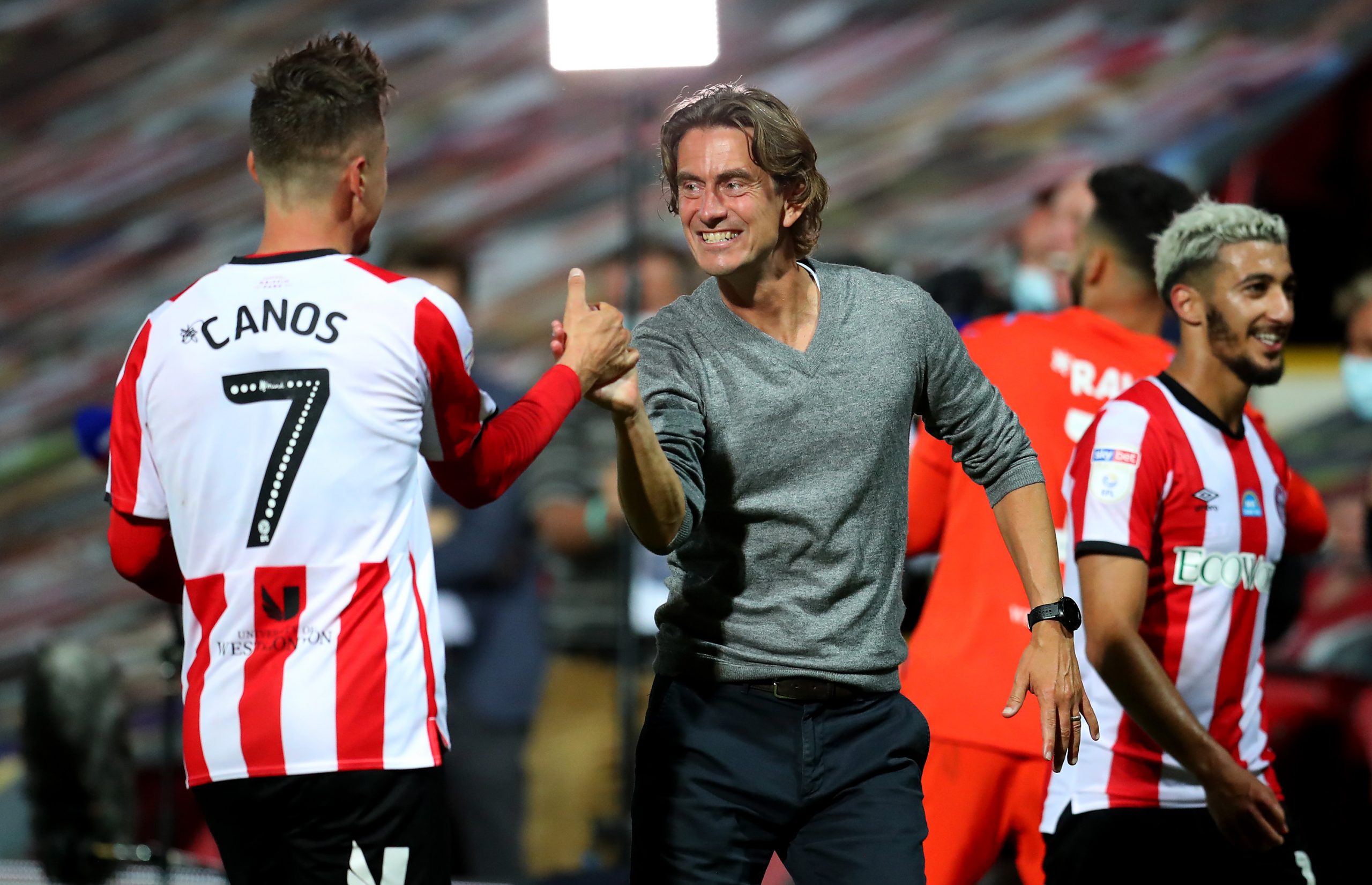 BRENTFORD, ENGLAND - JULY 29: Thomas Frank (R), head coach of Brentford celebrate with team mate Sergi Canós after the Sky Bet Championship Play Off Semi-final 2nd Leg match between Brentford and Swansea City at Griffin Park on July 29, 2020 in Brentford, England. Football Stadiums around Europe remain empty due to the Coronavirus Pandemic as Government social distancing laws prohibit fans inside venues resulting in all fixtures being played behind closed doors. (Photo by Catherine Ivill/Getty Images)