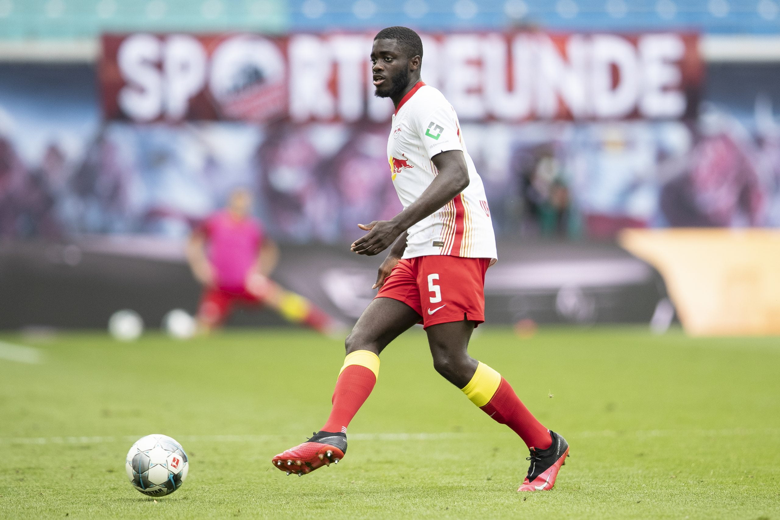 Chelsea remain 'busy in the market' for Upamecano who is in action in the picture