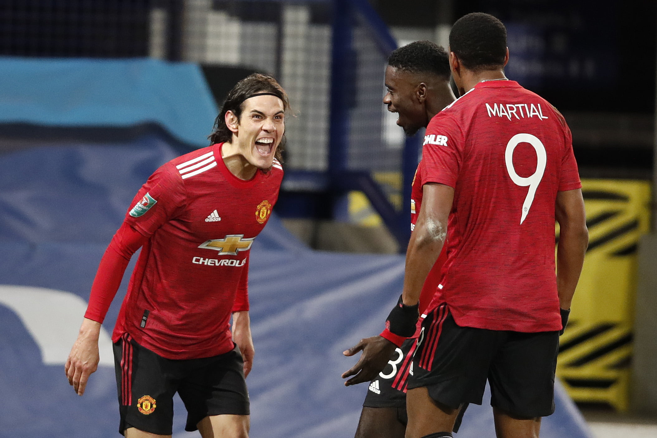 Edinson Cavani (l) of Manchester United celebrates with team mates Axel Tuanzebe and Anthony Martial (r) after scoring their sides first goal during the Carabao Cup Quarter Final match between Everton and Manchester United at Goodison Park on December 23, 2020 in Liverpool, England. (Photo by Clive Brunskill/Getty Images)