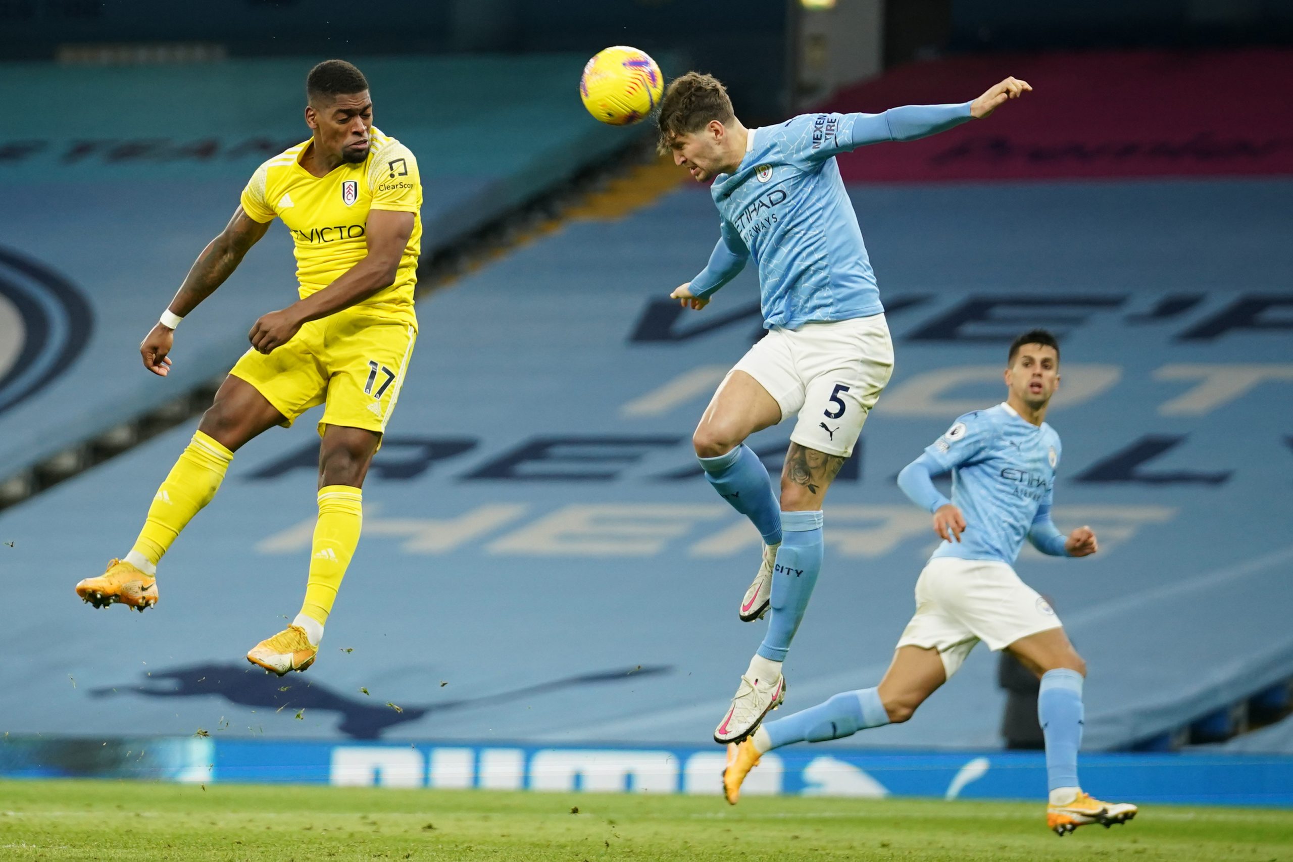 Fulham's Portuguese striker Ivan Cavaleiro (L) vies with Manchester City's English defender John Stones during the English Premier League football match between Manchester City and Fulham at the Etihad Stadium in Manchester, north west England, on December 5, 2020.  (Photo by DAVE THOMPSON/POOL/AFP via Getty Images)
