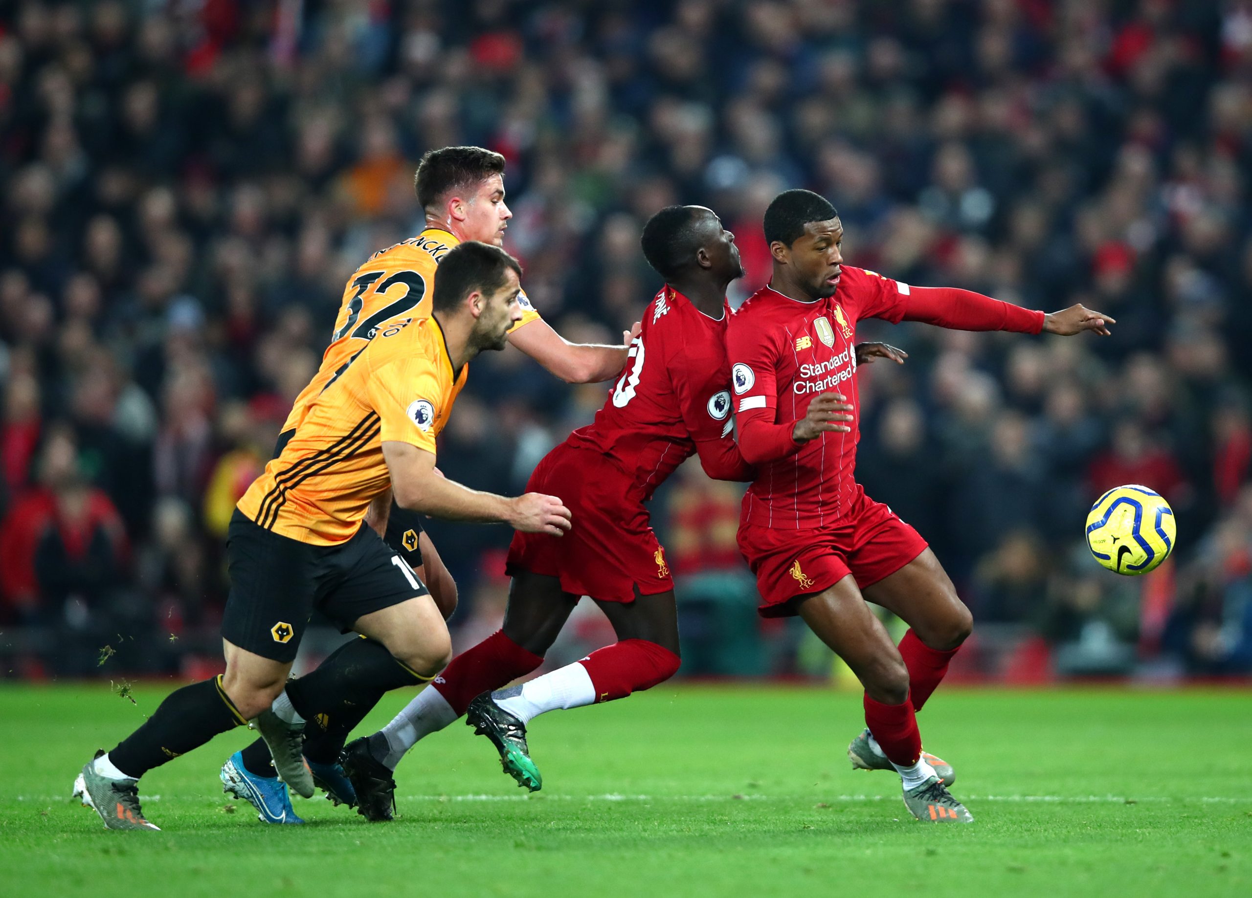 LIVERPOOL, ENGLAND - DECEMBER 29: Georginio Wijnaldum of Liverpool and Sadio Mane of Liverpool are closed down by Leander Dendoncker of Wolverhampton Wanderers during the Premier League match between Liverpool FC and Wolverhampton Wanderers at Anfield on December 29, 2019 in Liverpool, United Kingdom. (Photo by Clive Brunskill/Getty Images)