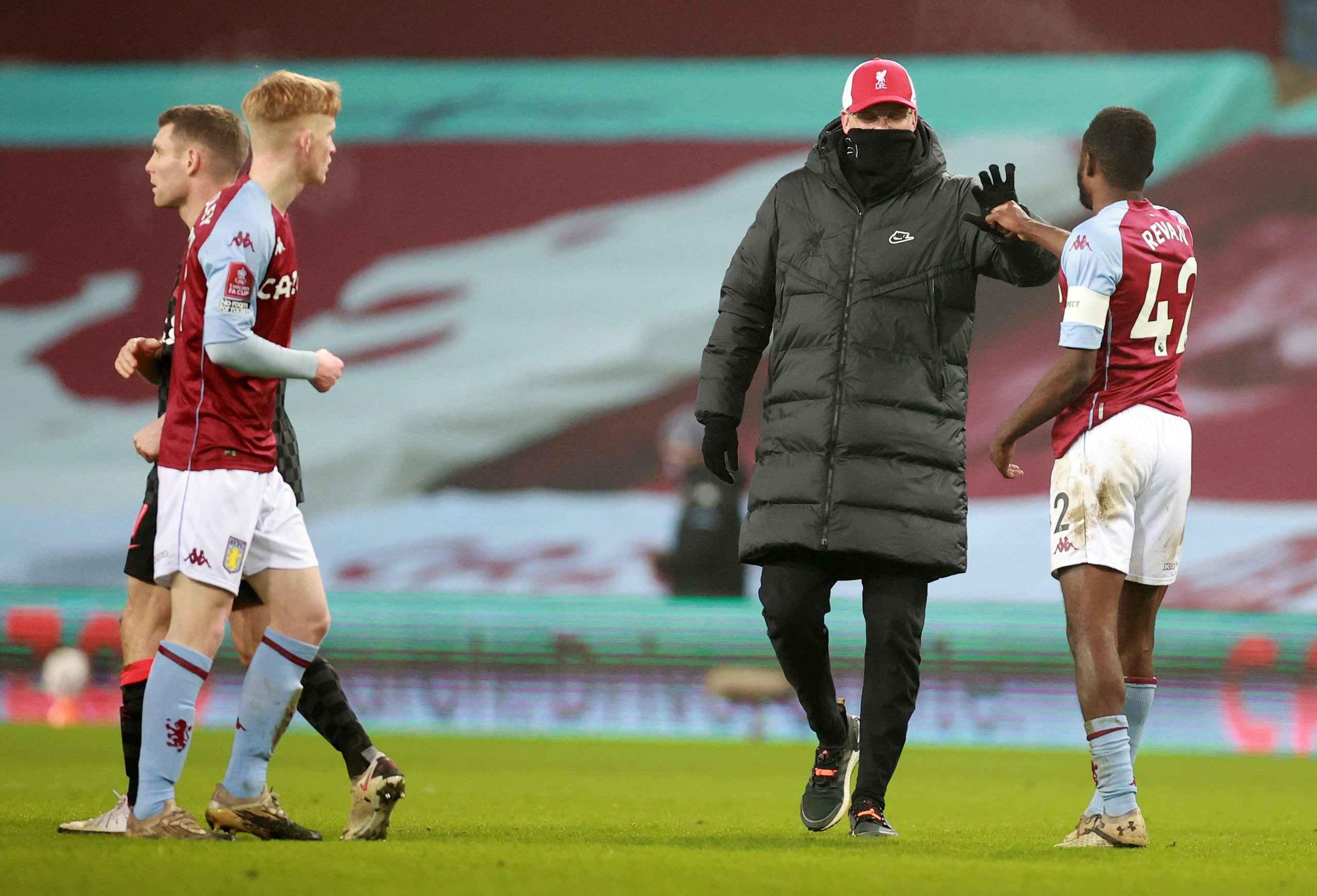 Liverpool's German manager Jurgen Klopp (2R) congratulates Aston Villa's English defender Dominic Revan (R) after the English FA Cup third round football match between Aston Villa and Liverpool at Villa Park in Birmingham, central England on January 8, 2021. - Liverpool won the match 4-1. (Photo by HANNAH MCKAY / POOL / AFP) / RESTRICTED TO EDITORIAL USE. No use with unauthorized audio, video, data, fixture lists, club/league logos or 'live' services. Online in-match use limited to 120 images. An additional 40 images may be used in extra time. No video emulation. Social media in-match use limited to 120 images. An additional 40 images may be used in extra time. No use in betting publications, games or single club/league/player publications. /  (Photo by HANNAH MCKAY/POOL/AFP via Getty Images)