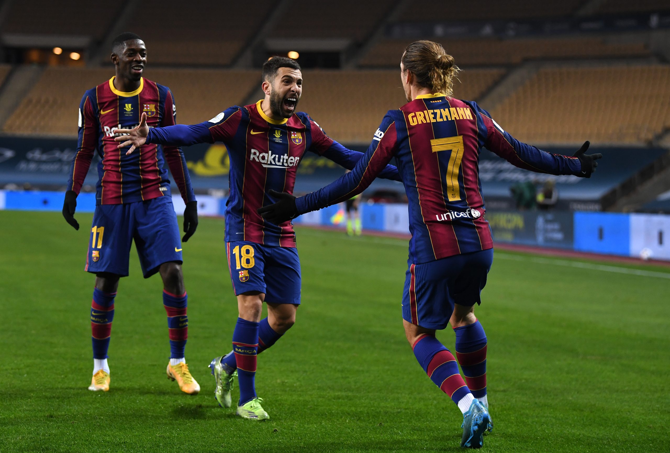 SEVILLE, SPAIN - JANUARY 17: Antoine Griezmann of Barcelona celebrates with team mates (L - R) Ousmane Dembele and Jordi Alba after scoring their side's second goal during the Supercopa de Espana Final match between FC Barcelona and Athletic Club at Estadio de La Cartuja on January 17, 2021 in Seville, Spain. Sporting stadiums around Spain remain under strict restrictions due to the Coronavirus Pandemic as Government social distancing laws prohibit fans inside venues resulting in games being played behind closed doors. (Photo by David Ramos/Getty Images)