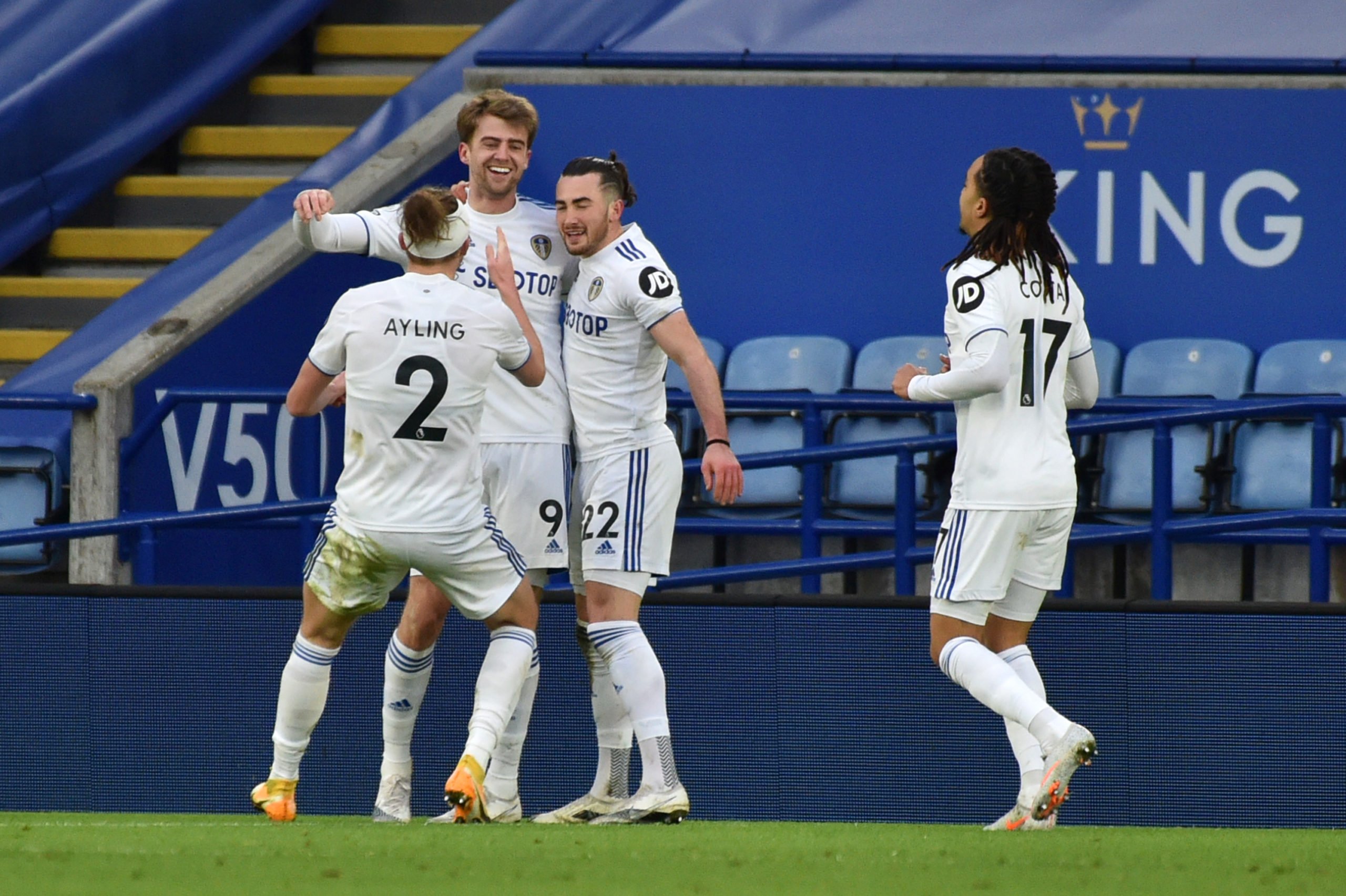 Jack Harrison of Leeds United celebrates with team mates (L - R) Luke Ayling, Patrick Bamford and Helder Costa after scoring their side's third goal during the Premier League match between Leicester City and Leeds United at The King Power Stadium on January 31, 2021 in Leicester, England. Sporting stadiums around the UK remain under strict restrictions due to the Coronavirus Pandemic as Government social distancing laws prohibit fans inside venues resulting in games being played behind closed doors. (Photo by Rui Vieira - Pool/Getty Images)