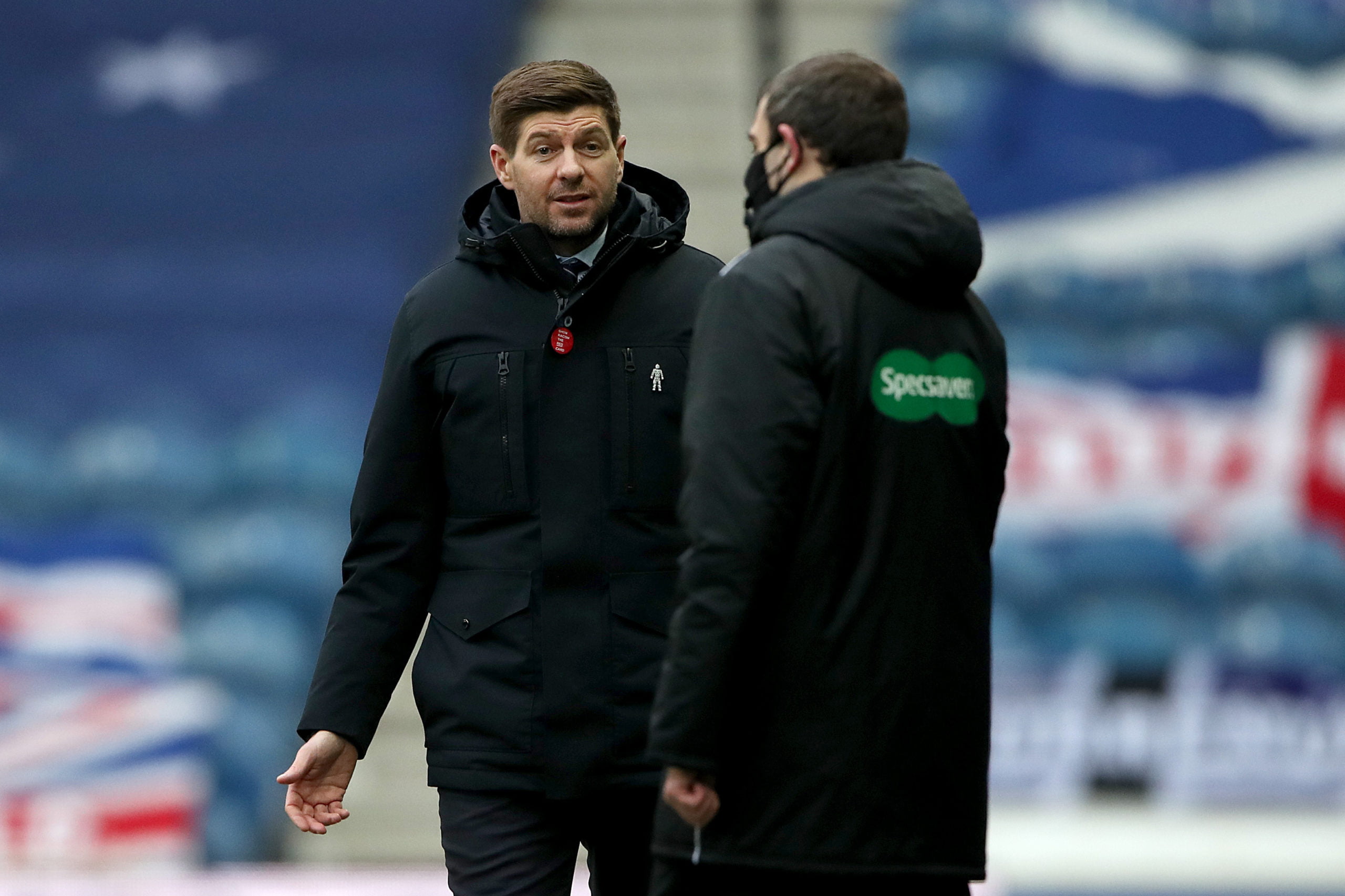 GLASGOW, SCOTLAND - FEBRUARY 13: Steven Gerrard, Manager of Rangers speaks with the Fourth Official during the Ladbrokes Scottish Premiership match between Rangers and Kilmarnock at Ibrox Stadium on February 13, 2021 in Glasgow, Scotland. Sporting stadiums around the UK remain under strict restrictions due to the Coronavirus Pandemic as Government social distancing laws prohibit fans inside venues resulting in games being played behind closed doors. (Photo by Ian MacNicol/Getty Images)